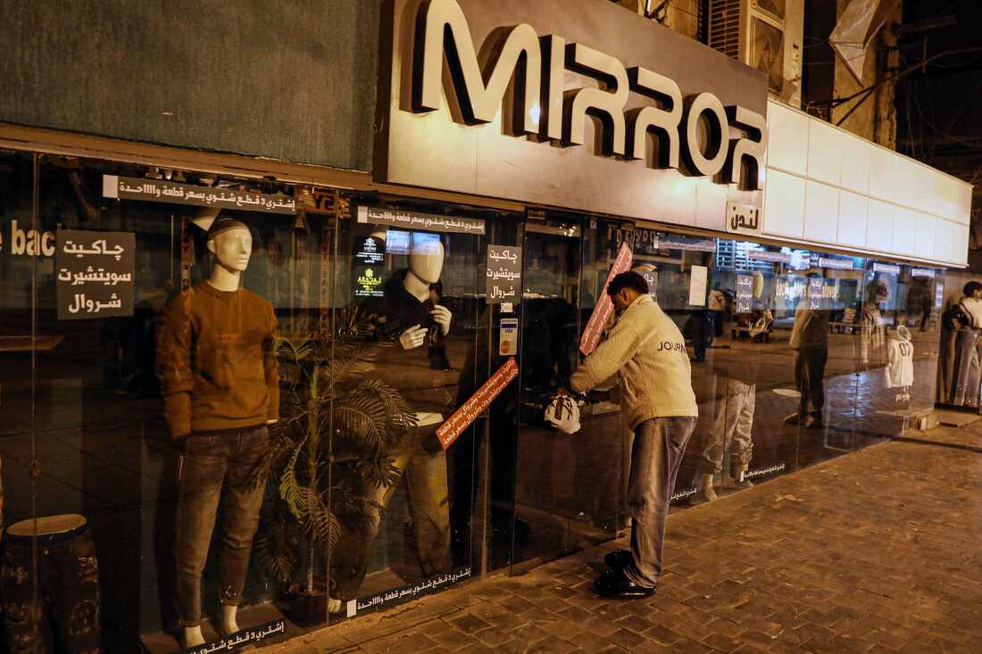 A man closes the door of a shop in Cairo, Egypt, March 30, 2026. TO GO WITH "Feature: Cairo's nights dim amid regional tensions, energy shortage."