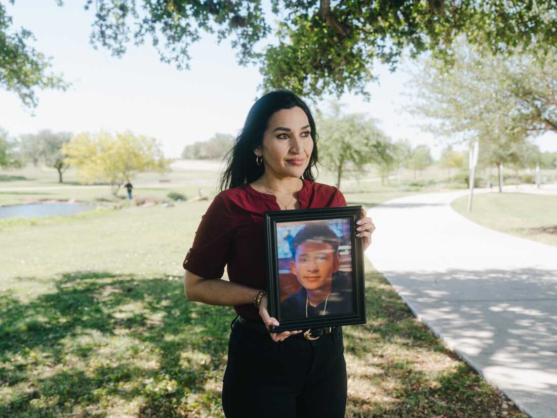 Rachel Reyes, holds a photo of her son, Ruben Ray Martinez.