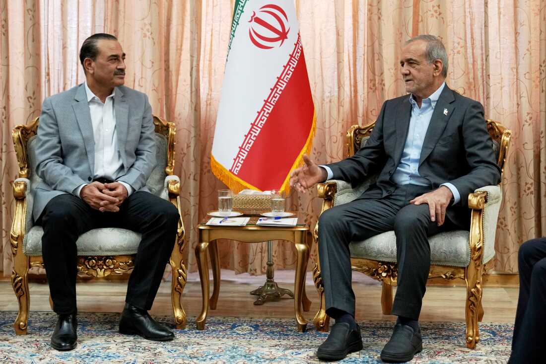 In this photo released by the Iranian Presidency Office, President Masoud Pezeshkian, right, speaks with Pakistan's Army Chief Field Marshal Gen. Asim Munir in Tehran, Iran, Saturday, May 23, 2026.