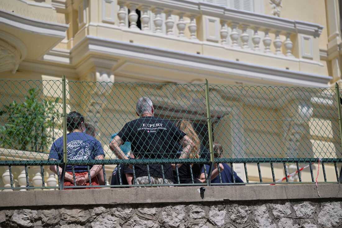 Investigators examine the scene at the residential building where an explosive device seriously injured three people a day earlier in Monaco, Tuesday, June 30, 2026.