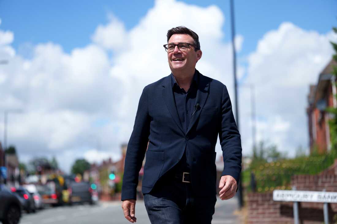 Andy Burnham smiles during a campaign visit to Ashton-in-Makerfield before a by-election, in Manchester, England, on June 9. Burnham is expected to succeed Keir Starmer as the U.K.'s Labour Party leader and prime minister. (AP Photo/Jon Super, file)